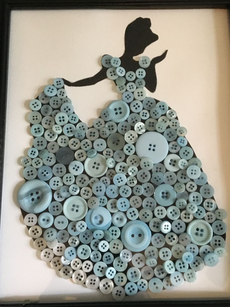 a shadow of a woman in a dress made out of buttons is mounted on the wall