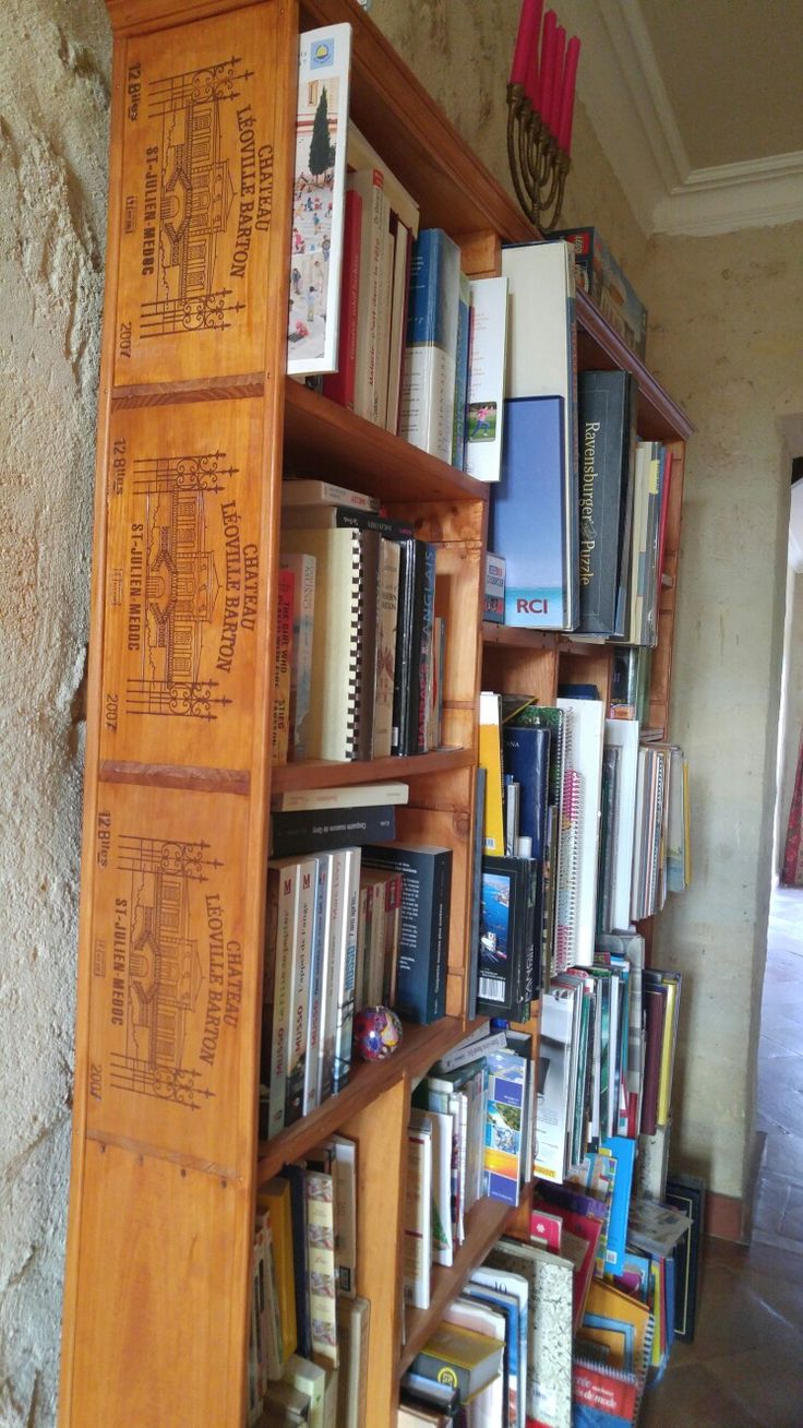 a bookshelf filled with lots of books next to a doorway