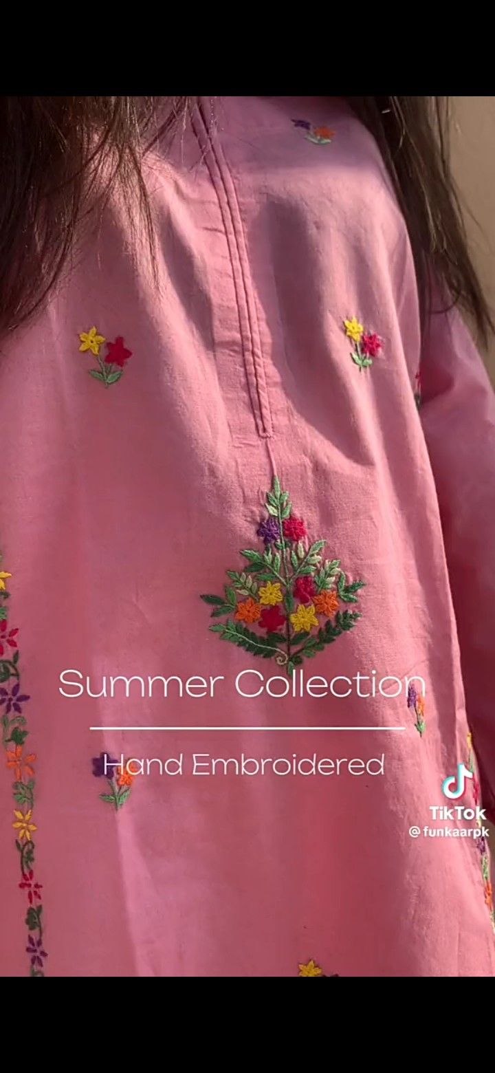 a woman wearing a pink shirt with colorful flowers on it and the words summer collection