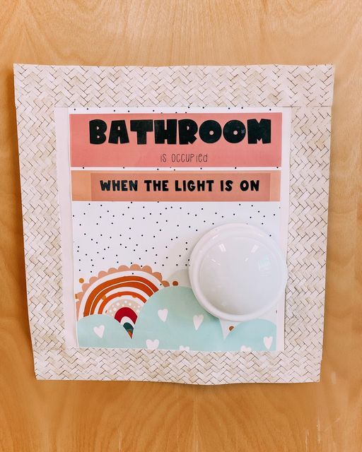 a bathroom magnet with the words when the light is on and a rainbow in the background