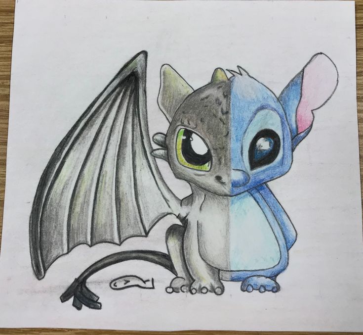 a pencil drawing of a dragon with big eyes sitting on top of a piece of paper