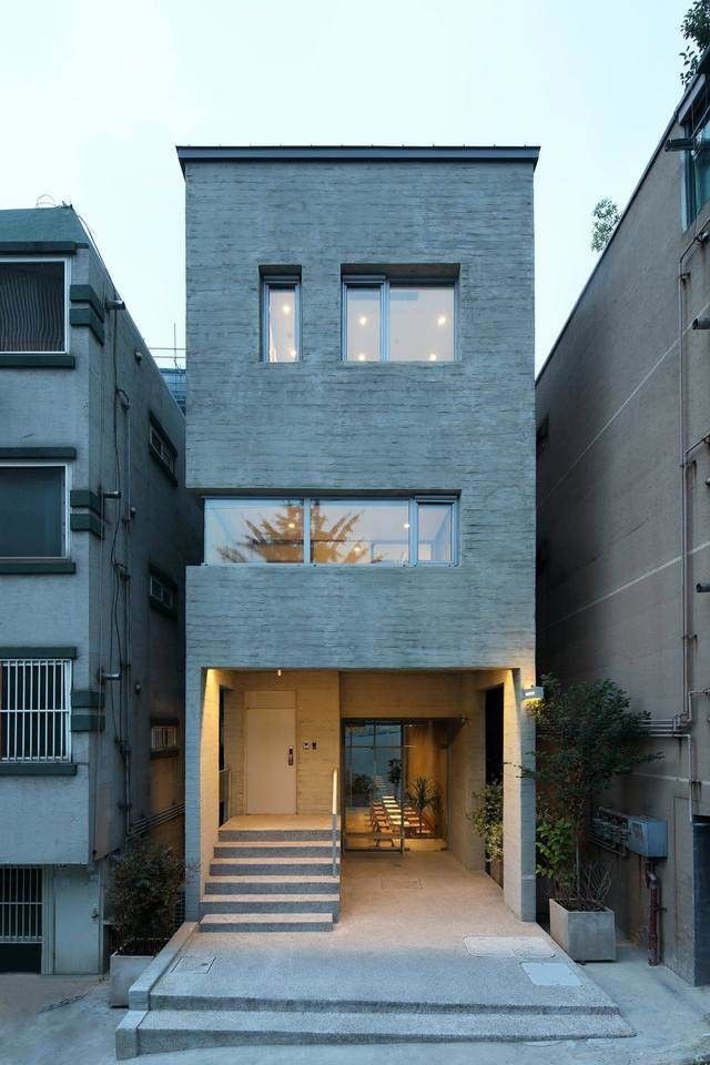 an apartment building with stairs leading up to it