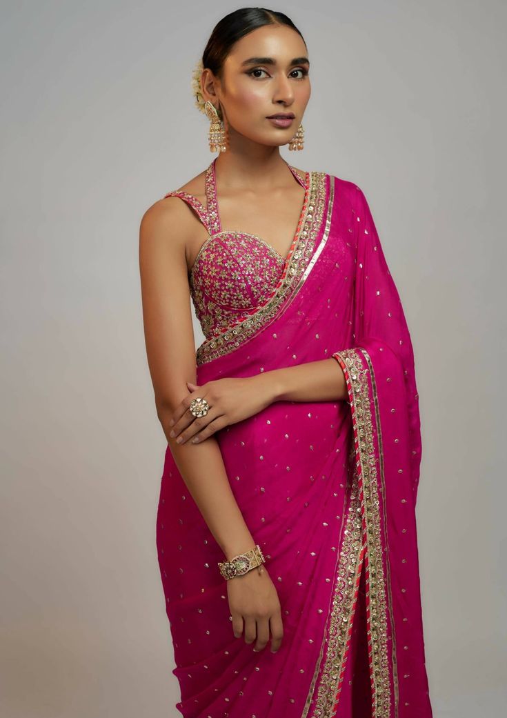 A classic badla sari with a delicate zardozi border is paired with a beautiful hand-embroidered double strap blouse. It speaks of opulence and grandeur, featuring gold and silver tones and jewel colors reminiscent of royalty. Sangeet Saree Outfit, Saree Styles Wedding Indian, Strap Blouses For Saree, Indiana Outfits, Rani Pink Blouse, Zardozi Border, Saree With Border, Mirror Blouse, Indian Fits