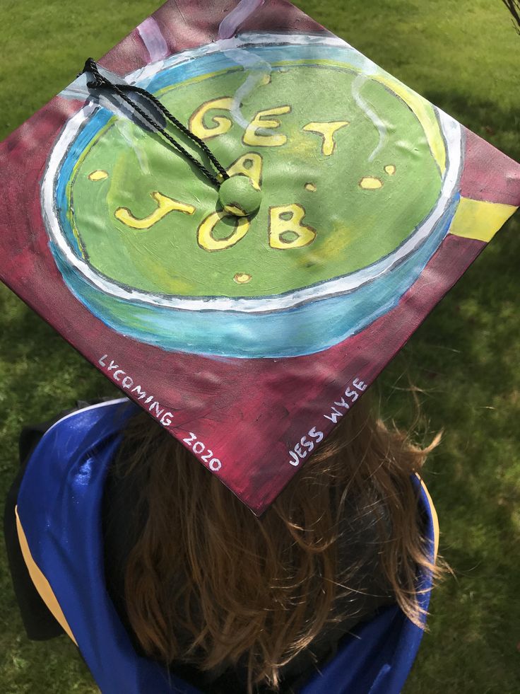 a child wearing a graduation cap with the words get job painted on it's side