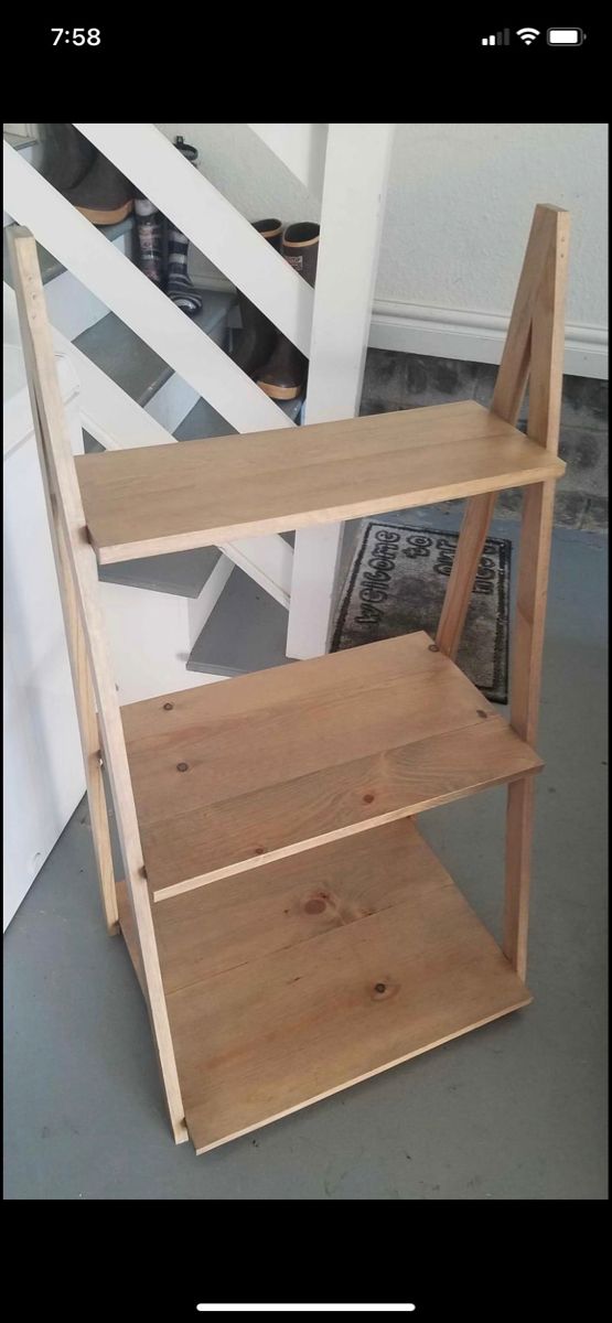 a wooden shelf sitting on top of a floor