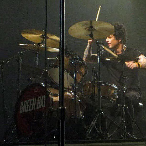 the drummer is playing drums on stage