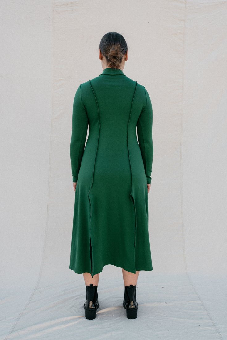 [meet me by our favorite fountain after two]Strut your stuff! The Ada in forest green is a long-sleeved, mock neck dress that is figure-hugging at the top and relaxed fitting from the waist down; with inviting two-way slits. This dress gives you a comfortable fit in all the right places, highlighting exposed seams with a stretch that is oh so cozy! •Mockneck collar•Super flattering fit•Slits in front and back•Exposed seams•Super cozy stretchAmari is 5'9", dress size 10, wearing a size L. Elle is High Neck Long Sleeve Dress For Fall, Winter High Neck Stretch Long Sleeve Dress, Dark Green Fitted Long Sleeve Midi Dress, Fitted Long Sleeve Dark Green Midi Dress, Fitted Dark Green Long Sleeve Midi Dress, Green Stretch Dress For Fall, Green Stretch Dresses For Fall, Fitted Green Midi Dress With High Neck, Dark Green Long Sleeve Midi Dress For Spring