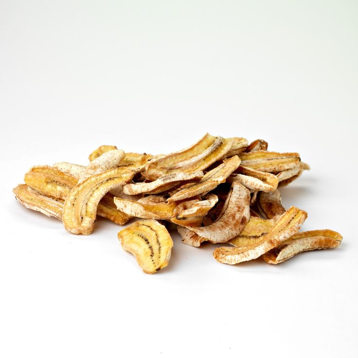 a pile of dried bananas sitting on top of a white table