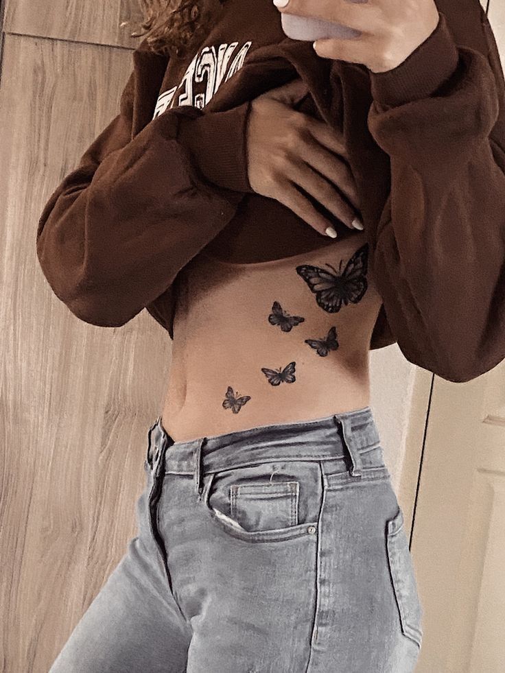 a woman is taking a selfie with her cell phone and butterflies on her stomach