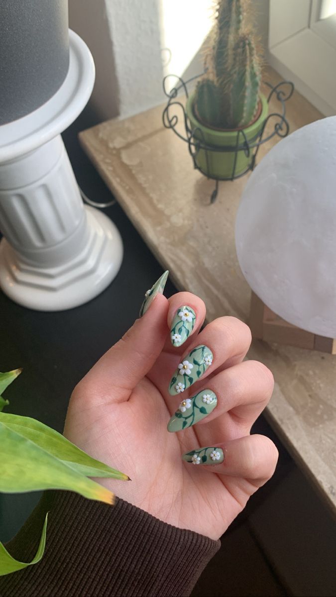 Sage Green Nails With Initial, Green Almond Nails With Flowers, Flower And Vine Nails, Green Nails Flower Design, Green Leaves Nail Art, Green And White Floral Nails, Green Nails With Vines, Green Nails Pink Flowers, Plant Theme Nails