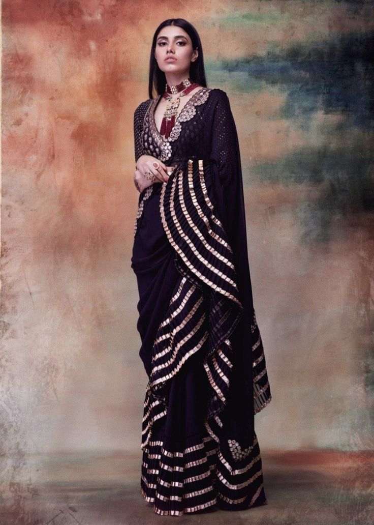 Editor's Note This set features a black mirror border and gota knife pleat saree. Neck: V-Neck Sleeve Type: Full Sleeves Fabric: Georgette Care: Dry Clean Only Customize Your Outfit Can't f... Luxury Black Saree With Resham Embroidery, Luxury Black Saree For Celebration, Luxury Black Katan Silk Blouse Piece, Luxury Black Self Design Saree, Luxury Georgette V-neck Blouse, Luxury Black Blouse Piece With Motifs, Luxury Long Sleeve Georgette Saree, Luxury Black Embroidered Saree, Luxury Black Self-design Saree