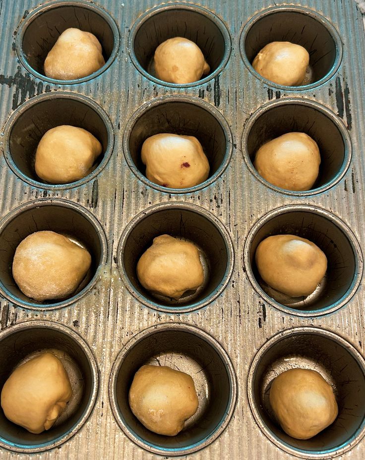 the doughnuts are ready to be baked in the muffin tins on the table