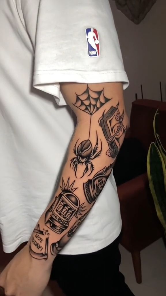 a man with a spider tattoo on his arm