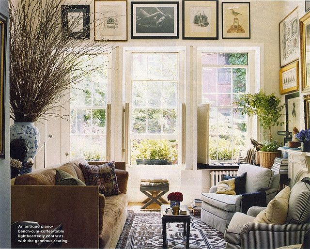 a living room filled with furniture and pictures on the wall