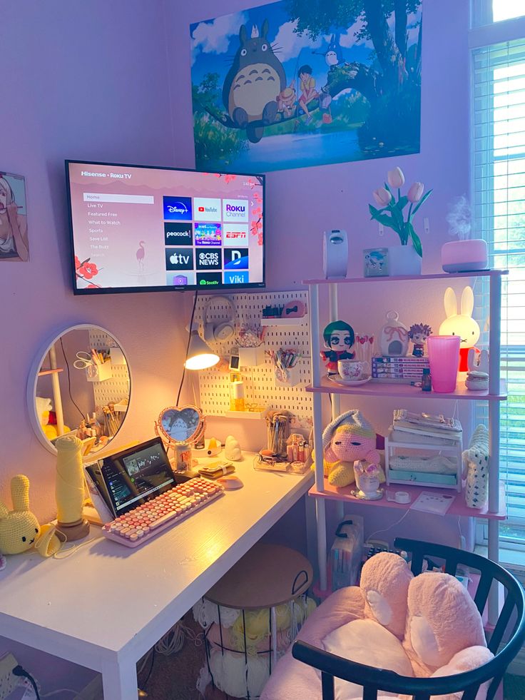 a desk with a computer, mirror and stuffed animals on it