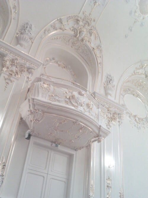 an ornately decorated room with white walls and doors