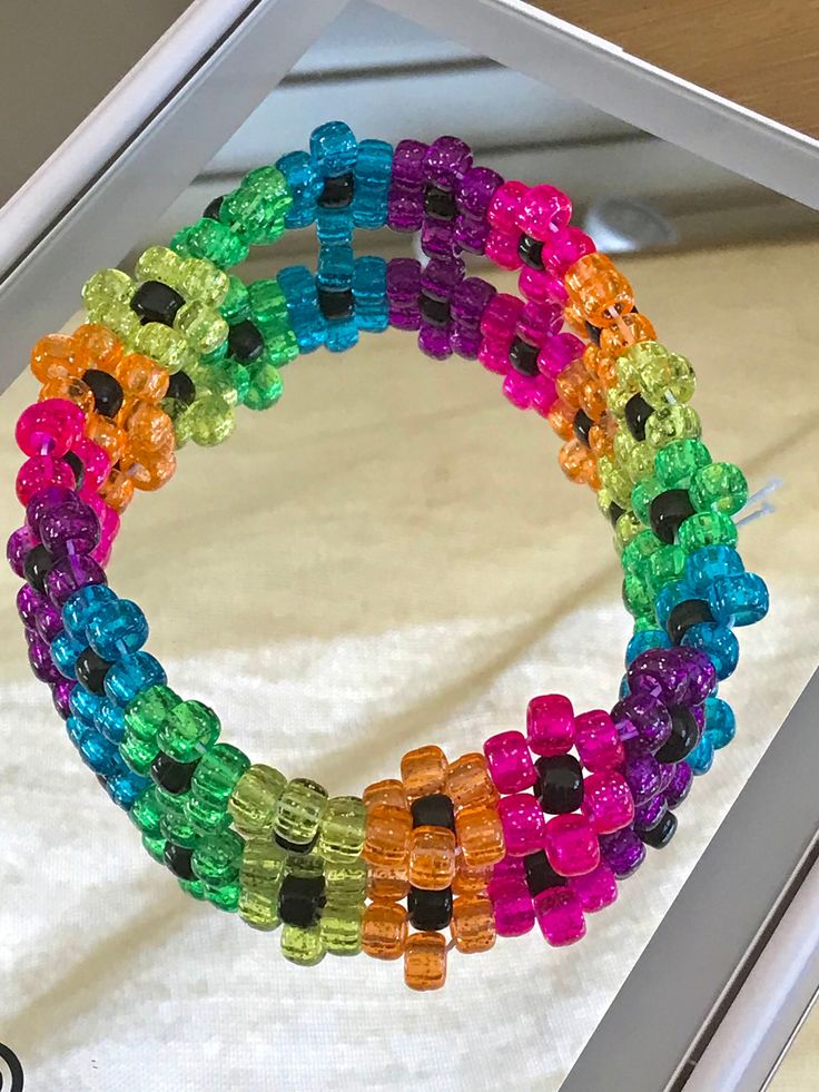 multicolored bracelets are displayed in a box