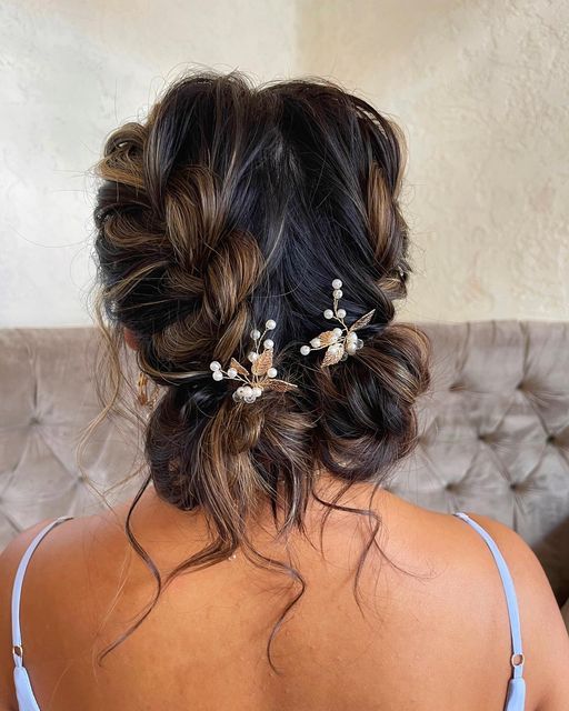 the back of a woman's head wearing a hair comb with flowers in it