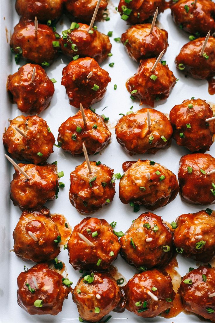 meatballs with toothpicks and garnishes on a tray