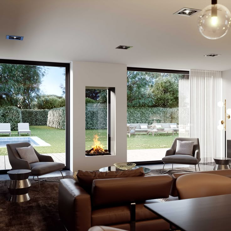 modern living room with fireplace and large glass doors that open to the backyard area outside