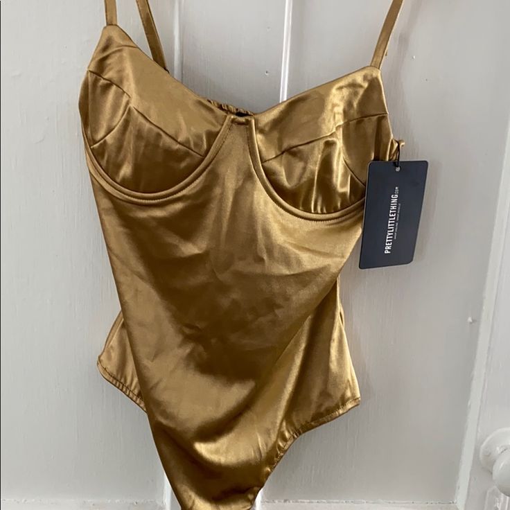 Nwt Silk Bodysuit, Nude Color Build In Bra. Never Worn Size Small. Elegant Gold Bodysuit For Summer, Gold Sleeveless Bodysuit For Night Out, Fitted Gold Bodysuit For Beach, Chic Underwire Bodysuit For Party, Chic Gold Swimwear For Night Out, Gold Bodysuit For Night Out, Fitted Underwire Bodysuit For Party, Party One-piece Bodysuit With Built-in Bra, Solid Bodysuit With Built-in Bra For Parties