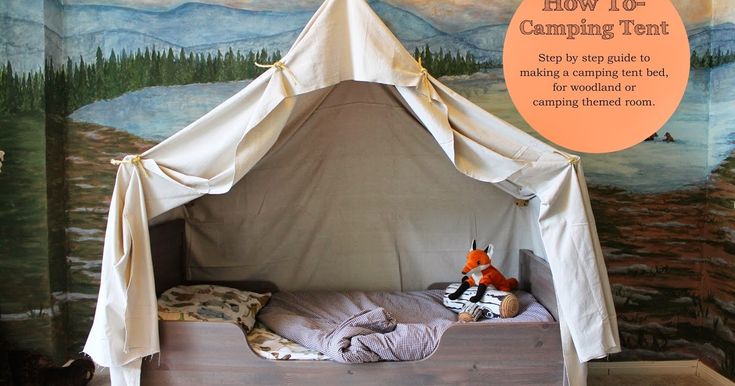 a child's bed with a canopy over it in front of a painting on the wall