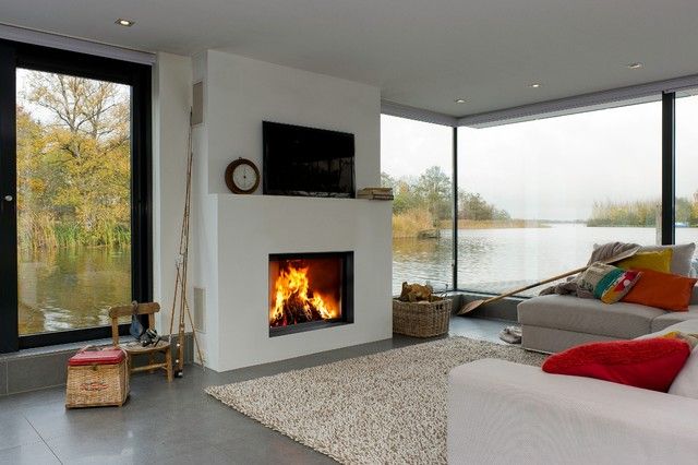 a living room with a fire place and large windows