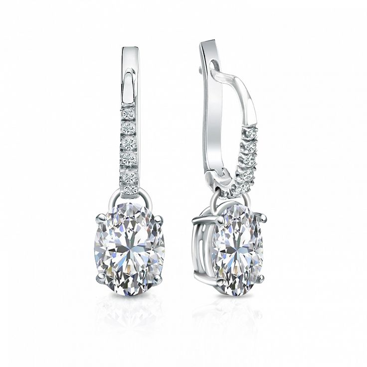 Dangle studs 4-prong basket set diamond earrings make an elegant statement for any occasion. These 18k white gold earrings can last a lifetime. The earrings feature oval-cut natural diamonds with 2.00 ct. total weight for center stone and with 0.10 ct. total weight of small dazzling round-cut diamonds as side stone totaling to 2.10 ct. in a complete pair, available in lever back clasps. Black Diamond Pendant, Black Diamond Studs, Halo Diamond Earrings, Solitaire Diamond Pendant, Colored Diamond Rings, Platinum Earrings, Black Diamond Ring, Earrings Dainty, White Gold Earrings