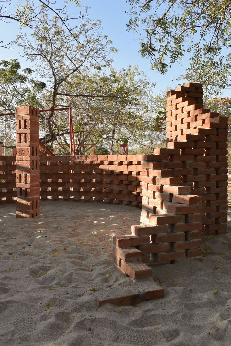 a pile of bricks sitting on top of a sandy ground