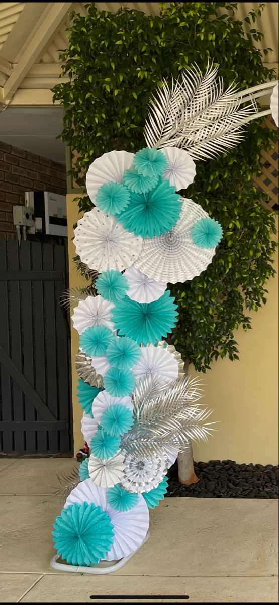 a tall white and blue paper flower decoration