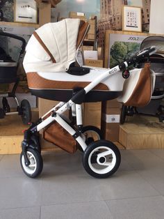 a baby stroller sitting on top of a tiled floor