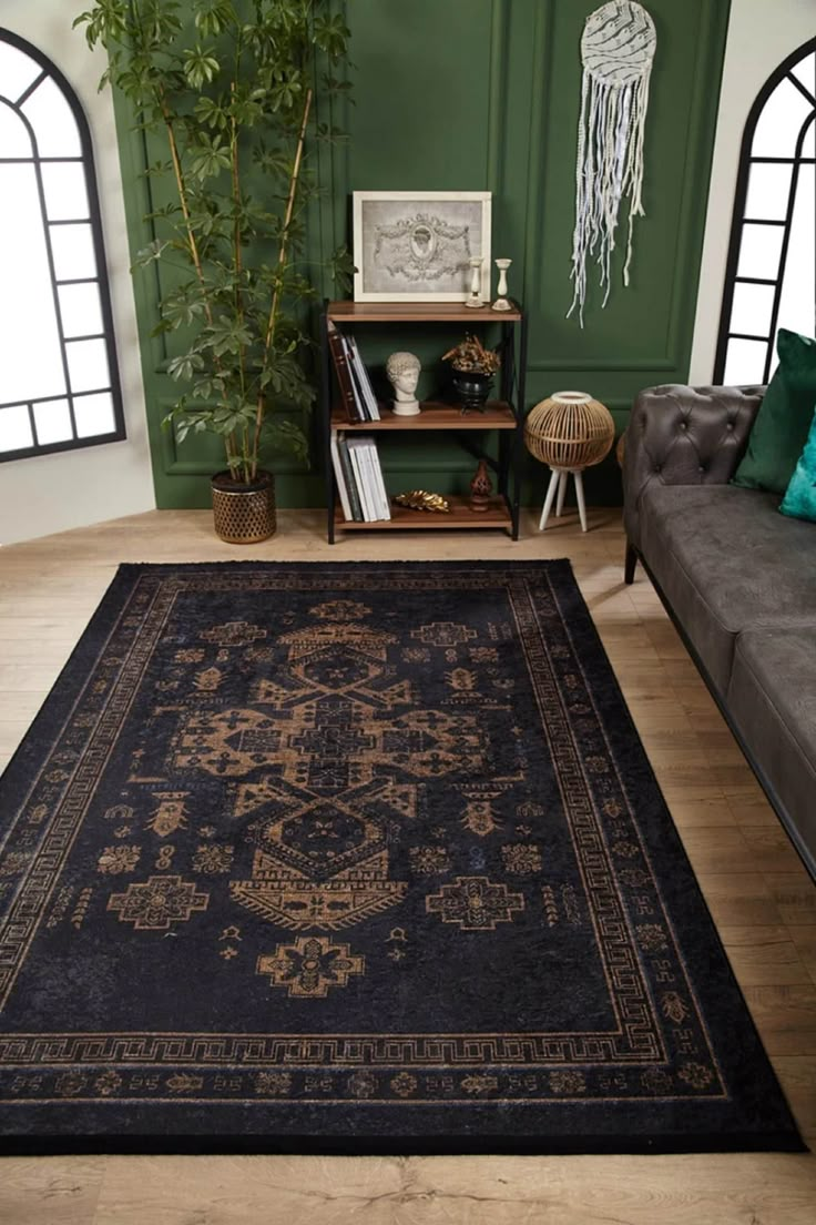 a living room filled with furniture and a rug on top of a hard wood floor