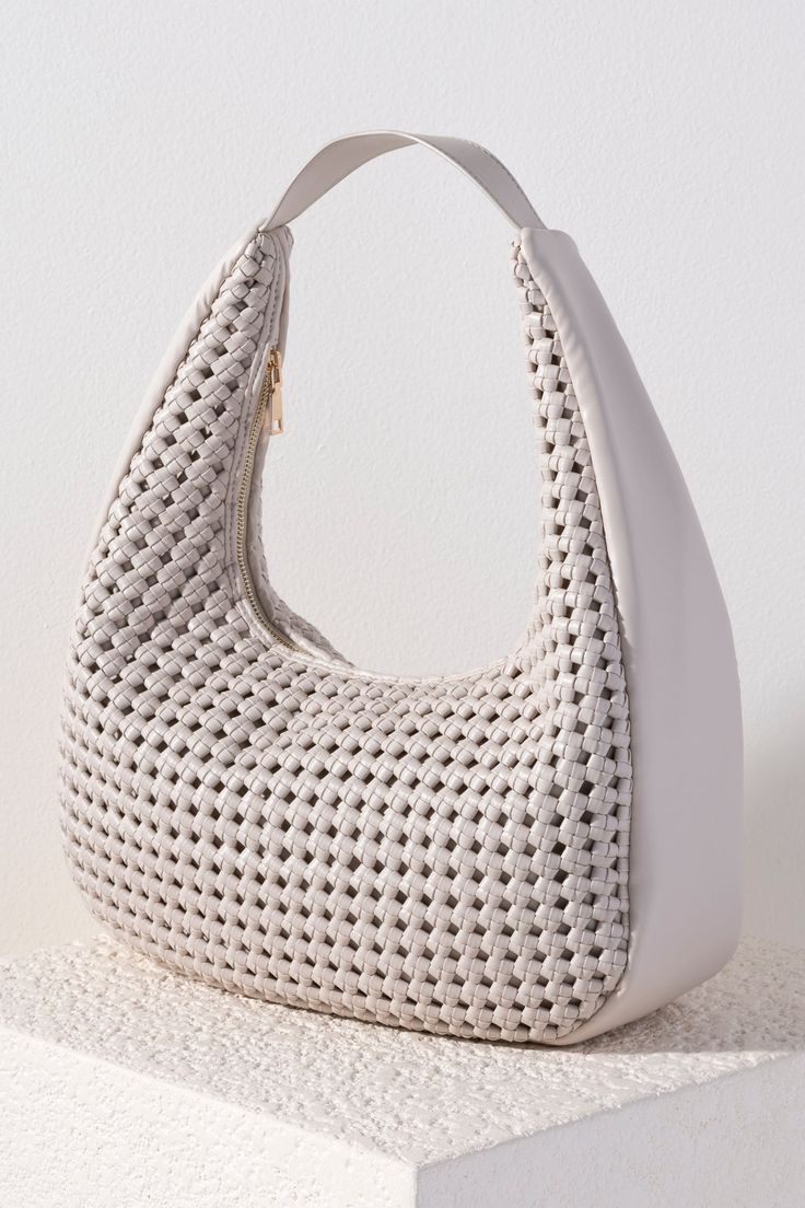 Carry all of your summer essentials in style with Shiraleah's Monroe Hobo. Made of elegant handwoven vegan leather, this purse is your new favorite summer handbag. Its single shoulder strap allows you to wear it easily over your arm. Pair with other items from Shiraleah to complete your look! Chic Beige Braided Crochet Bag, Chic Beige Crochet Bag With Woven Leather, Chic Beige Crochet Bag With Woven Leather Details, Chic Braided Straw Bag, Spring Woven Hobo Bag With Double Handle, Woven Hobo Bag With Double Handle For Spring, Summer Hobo Bag With Open Weave For Everyday Use, Spring Woven Double Handle Hobo Bag, Summer Open Weave Hobo Bag For Everyday Use