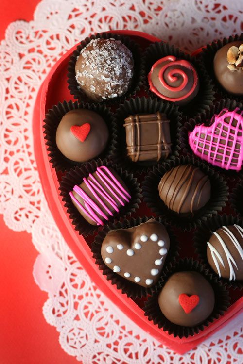 a heart shaped box filled with assorted chocolates