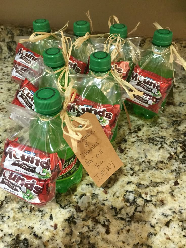 six bottles of mountain dew are sitting on a granite counter with a note attached to the bottle