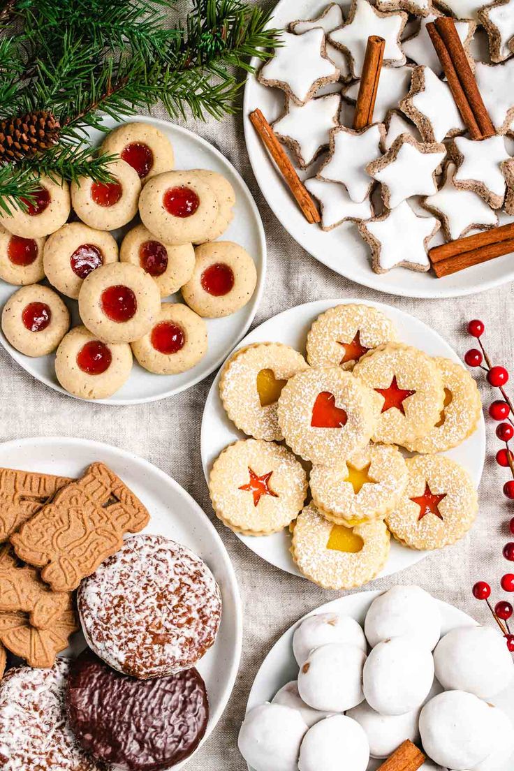 german christmas cookies are arranged on white plates