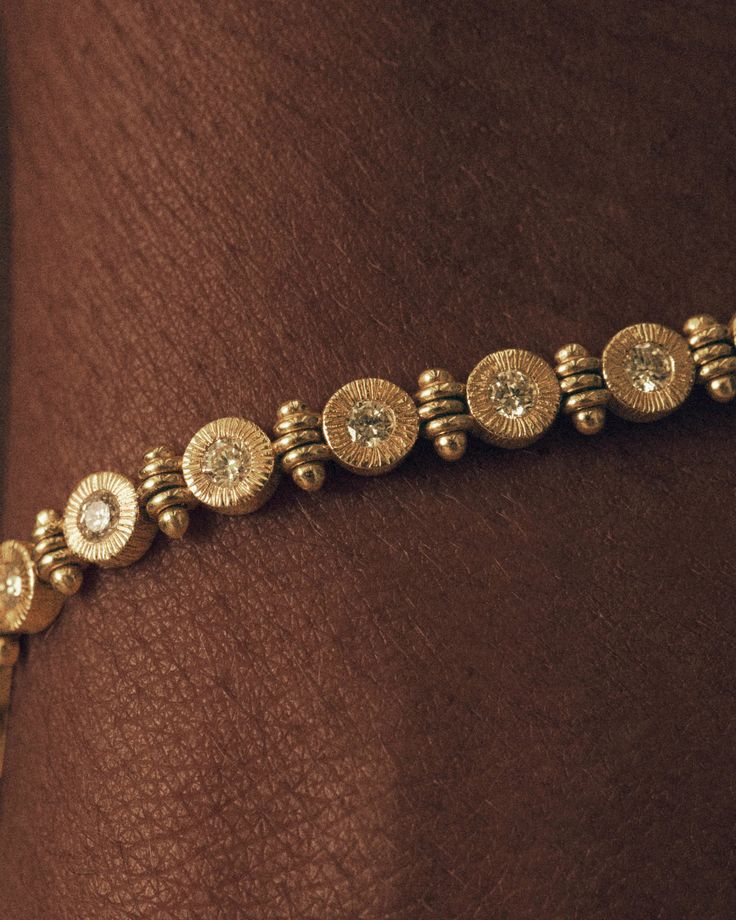 Lucy Folk evolves the classic gold tennis bracelet to bring a new energy in a string of diamonds bound in textured round bezel settings of 18ct gold. Crafted with a fluid, articulated chain that sits against the body, this piece is intended to be adored by its wearer, a celebration of self-love in its purest form.##Composition: *18ct Yellow Gold*16.5cm Total Length*24 x 0.05ct round Round Faceted Natural Diamonds Timeless Bracelet, Yellow Diamond Bracelet, Gold Tennis Bracelet, Textured Bracelet, Accesories Jewelry, Fruit Jewelry, Stacked Jewelry, Tennis Bracelet Diamond, Classy Jewelry