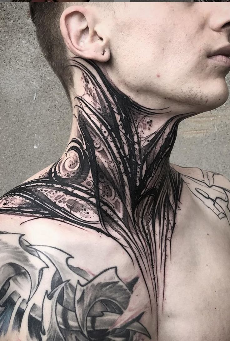 a man with tattoos on his neck and chest