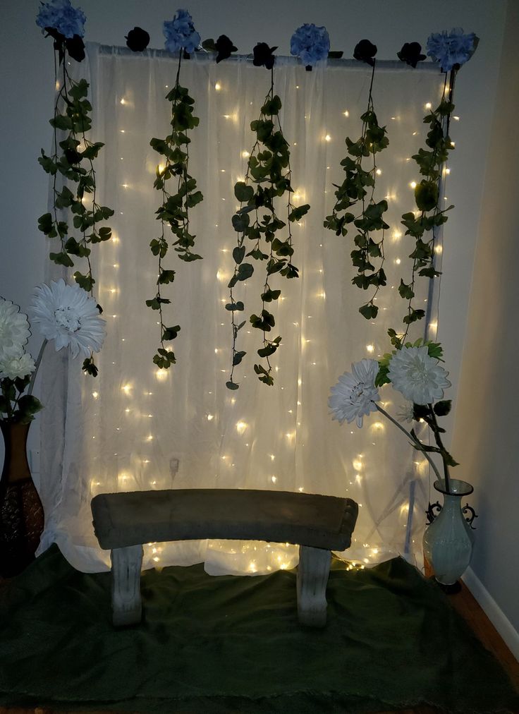 a bench sitting in front of a curtain with flowers on it