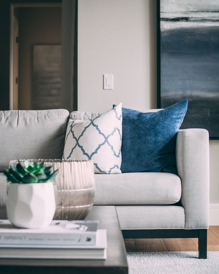 a living room with a couch, coffee table and painting