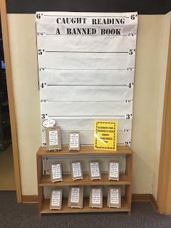 there is a sign that says caught reading a banned book in front of the bookshelf