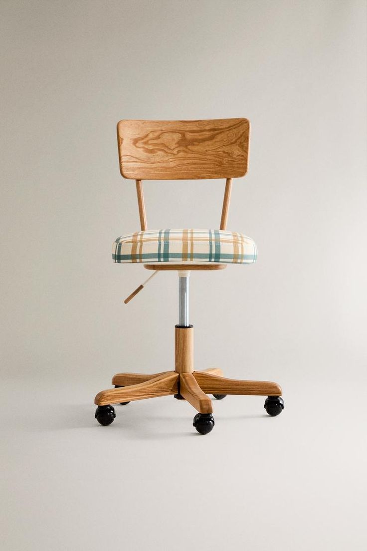 a wooden chair with a plaid seat pad on it's back and casteors