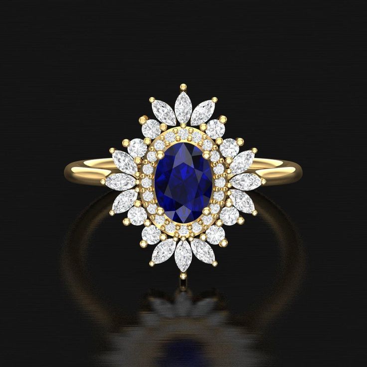 an oval shaped blue sapphire and diamond ring in yellow gold with diamonds on the sides