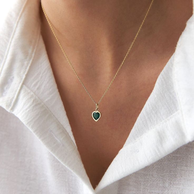 This elegant green heart necklace is crafted with 14k solid gold, embodying timeless beauty and sophistication. Its minimalist design, combined with the finest craftsmanship, makes it a perfect piece for everyday wear or a meaningful gift for a loved one. This necklace is crafted with real 14k solid gold(not plated, not vermeil, not gold filled) You don't need to worry about water, perfume or conditioner contact since real gold doesn't tarnish. The center is a heart cut green cubic zirconia bezel set delicately into the gold frame. This ensures that your piece keeps its beauty for decades to come. You can even wear this piece in water as well. Green Heart Necklace, 20 Inch Necklace, Mesmerizing Beauty, About Water, August Birthstone Jewelry, July Birthstone Jewelry, Green Heart, Gold Colors, Zodiac Jewelry