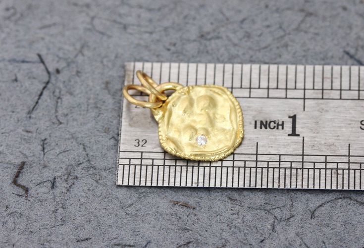 "A solid gold pendant set with a diamond, in 14k or 18k solid yellow, white or rose gold, in a boho antique style design. This solid gold antique-style pendant has a rustic textured and is set with a natural white diamond. The pendant has a gold arc on top, in which there are 2 gold loops, and has a delicate granulation all around it. This pendant is delicate but has a lot of character, and will upgrade any outfit you'll wear. This is a lovely pendant for everyday use, as for special occasions. Hammered Yellow Gold Coin Jewelry, Antique Yellow Gold Jewelry With Hammered Details, Heirloom Gold Jewelry With Diamond Accents, Antique Hammered Yellow Gold Jewelry, Diamond Coin Pendant Jewelry For Anniversary, Elegant Hammered Coin Jewelry, Gold Medallion With Single Cut Diamonds, Hammered Pendant In Fine Jewelry Style, 14k Gold Hammered Pendant Jewelry