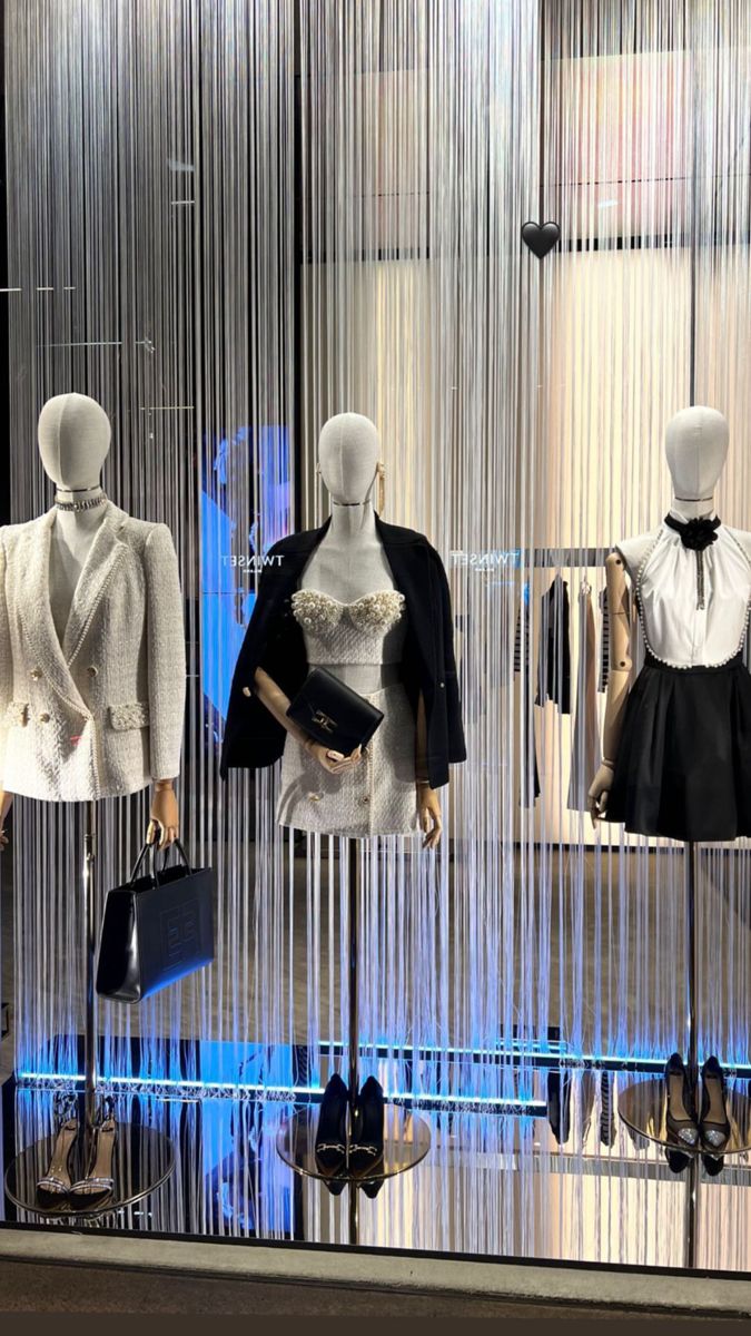 mannequins dressed in black and white clothes on display