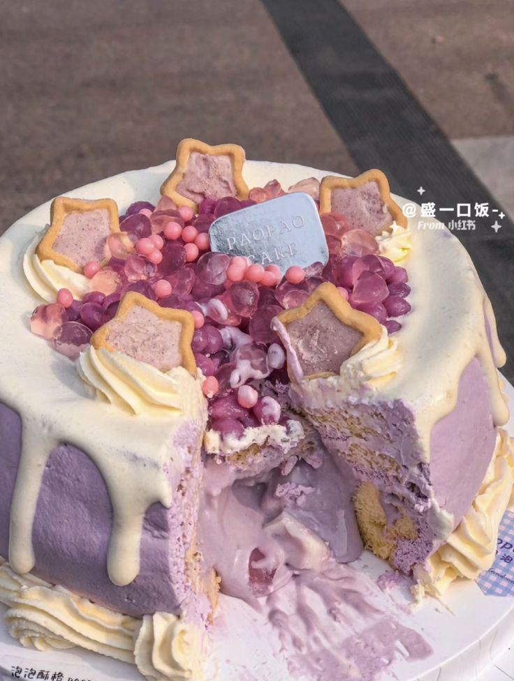 there is a cake that has been cut in half and covered with purple frosting