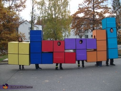 some people are standing in the middle of a group of cubes