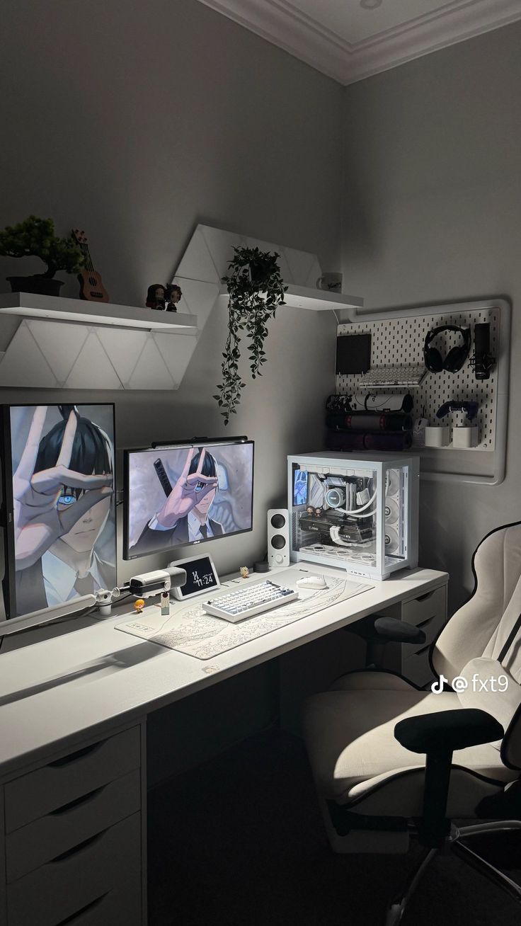 two computer monitors sitting on top of a desk