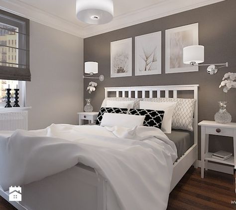 a white bed sitting in a bedroom on top of a hard wood floor next to a window